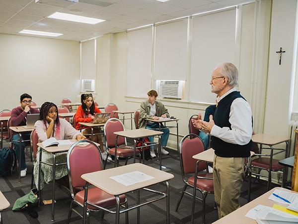 Professor speaking to students in a classroom